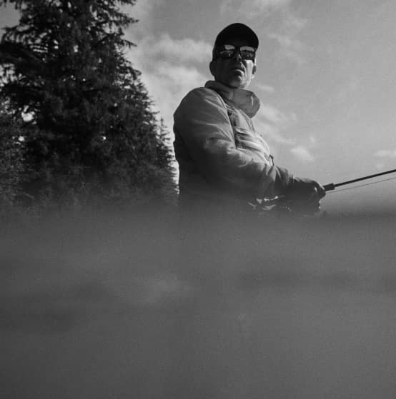 Angler casting beside misty water