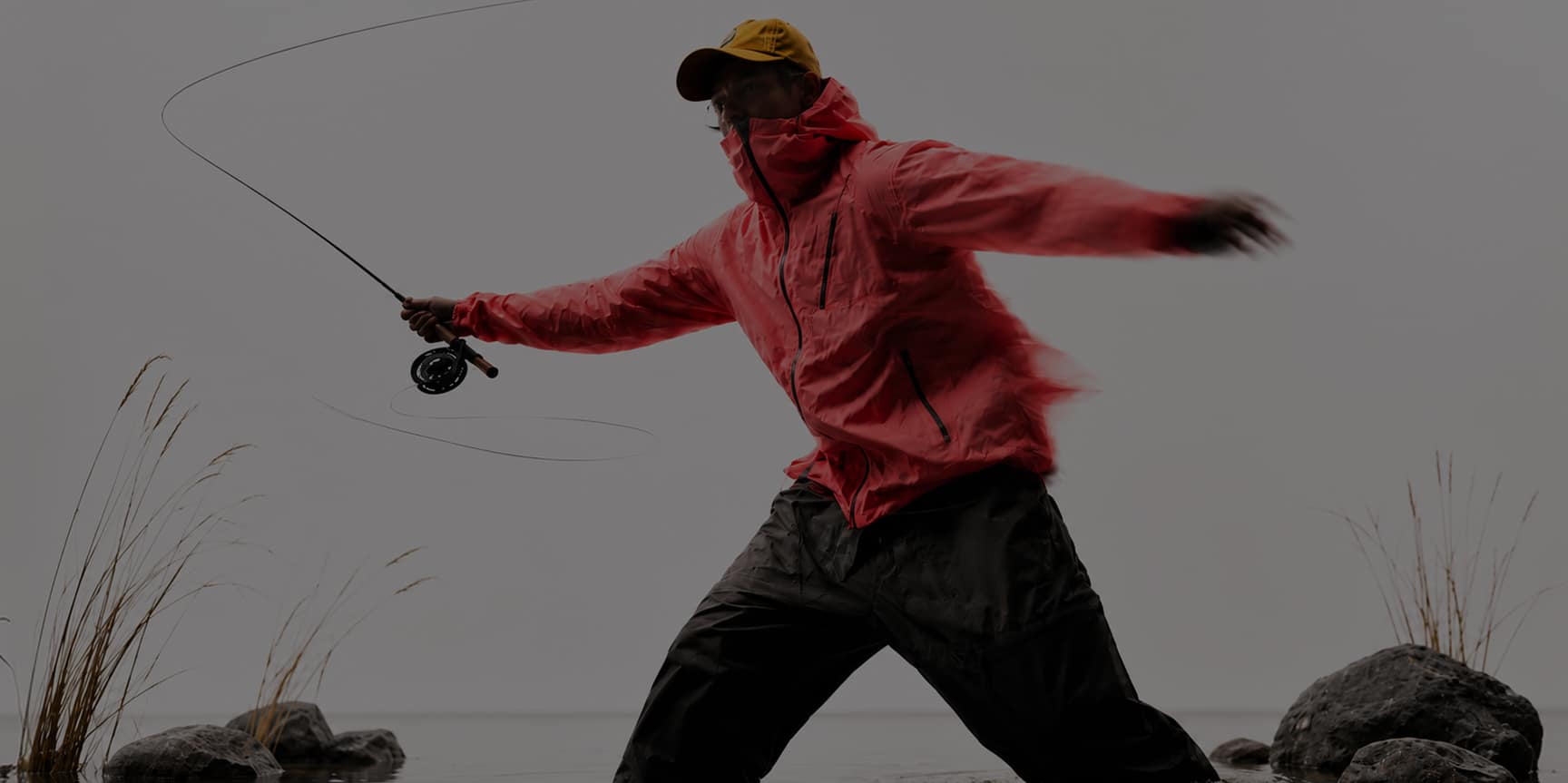 Angler casting in misty water