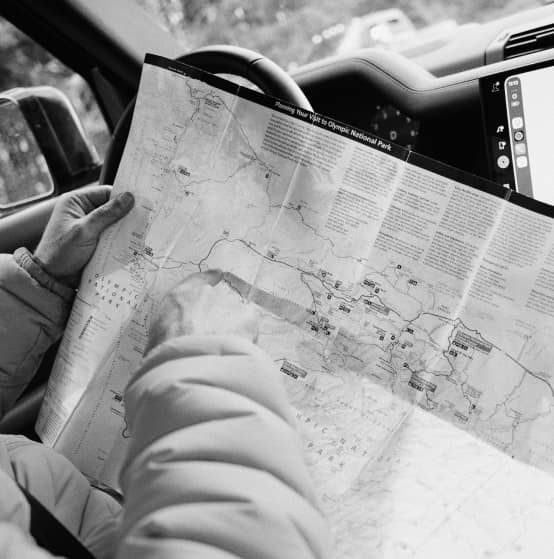 Hands holding a map inside a vehicle